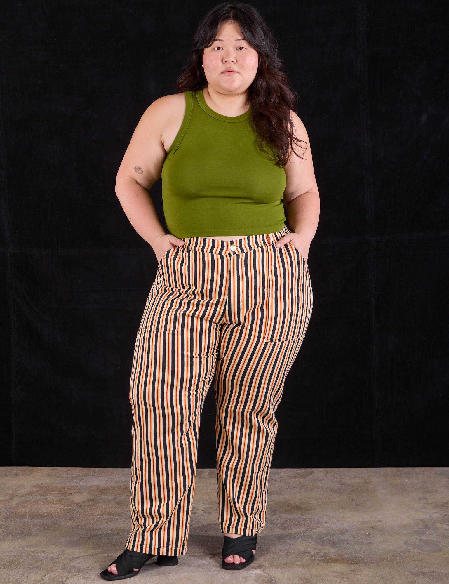 Ashley is 5&#39;7&quot; and wearing 1XL Work Pants in Autumn Stripe paired with summer olive Racerback Tank