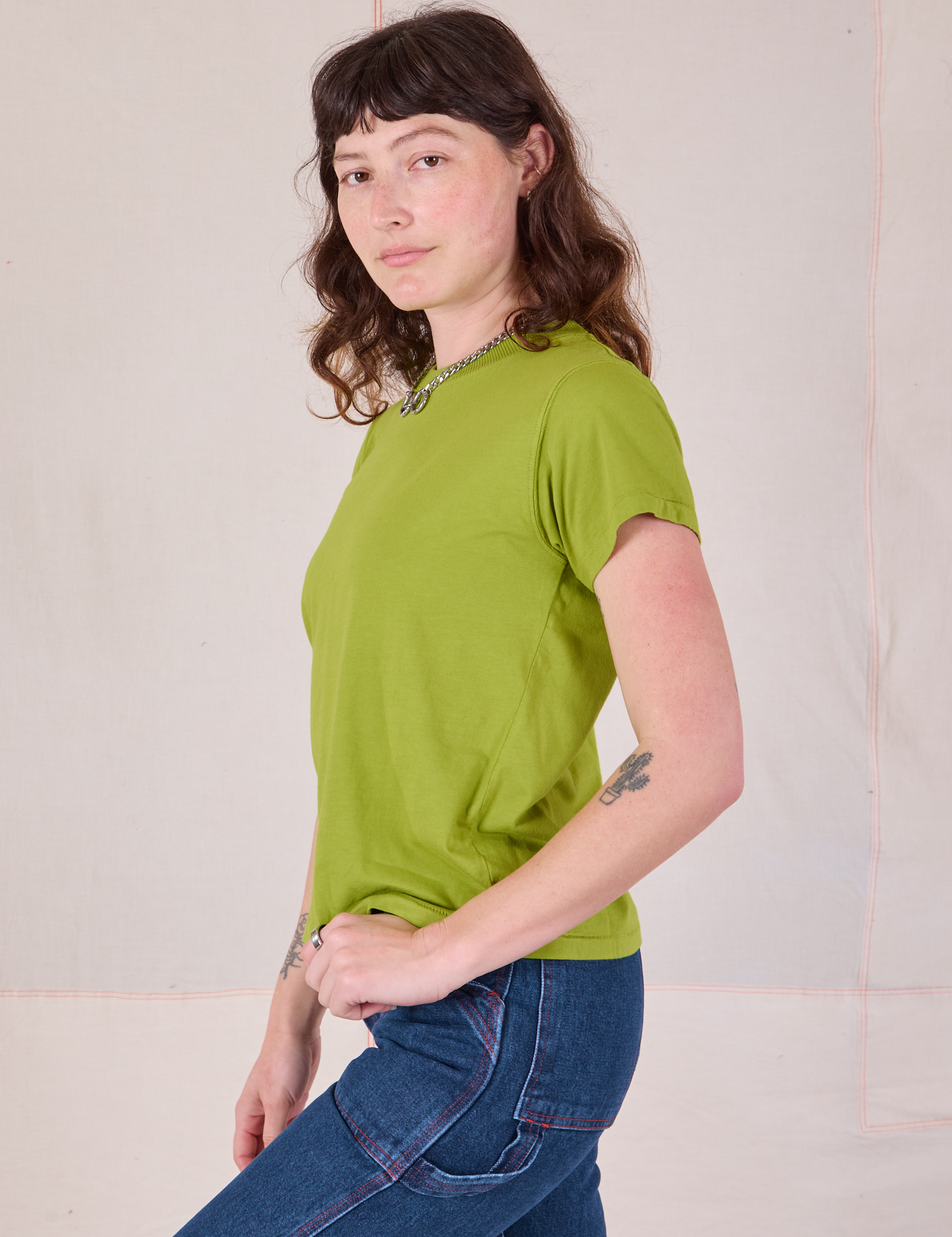 Side view of Organic Vintage Tee in Gross Green on Alex