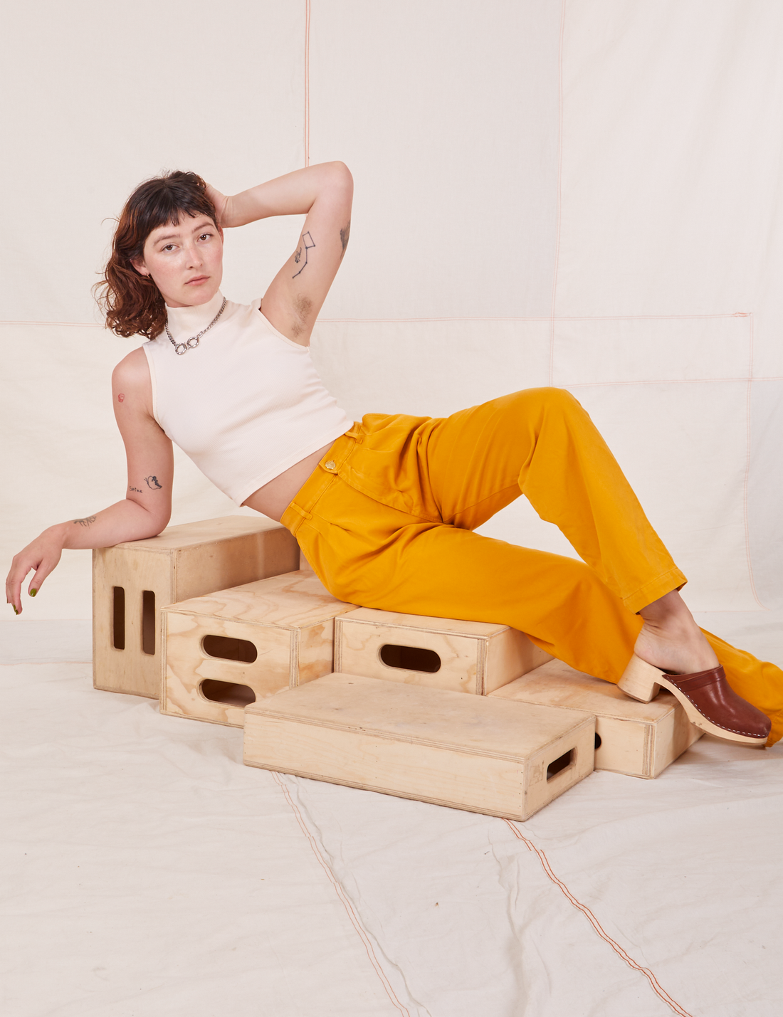 Organic Trousers in Mustard Yellow and vintage off-white Sleeveless Essential Turtleneck worn by Alex