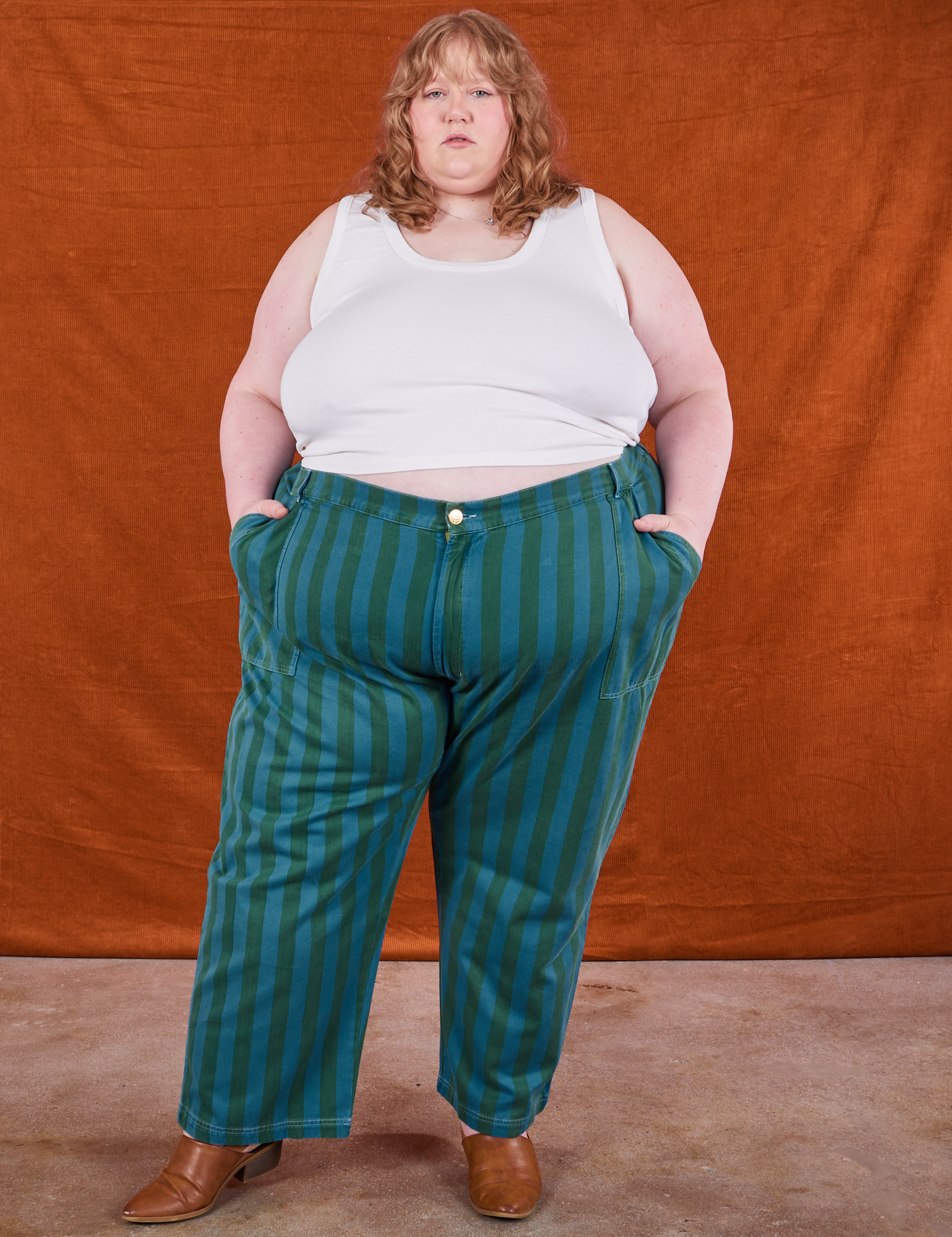 Catie is 5&#39;11&quot; and wearing size 6XL Overdye Stripe Work Pants in Blue/Green paired with vintage off-white Tank Top