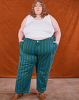 Catie is 5'11" and wearing size 6XL Overdye Stripe Work Pants in Blue/Green paired with vintage off-white Tank Top
