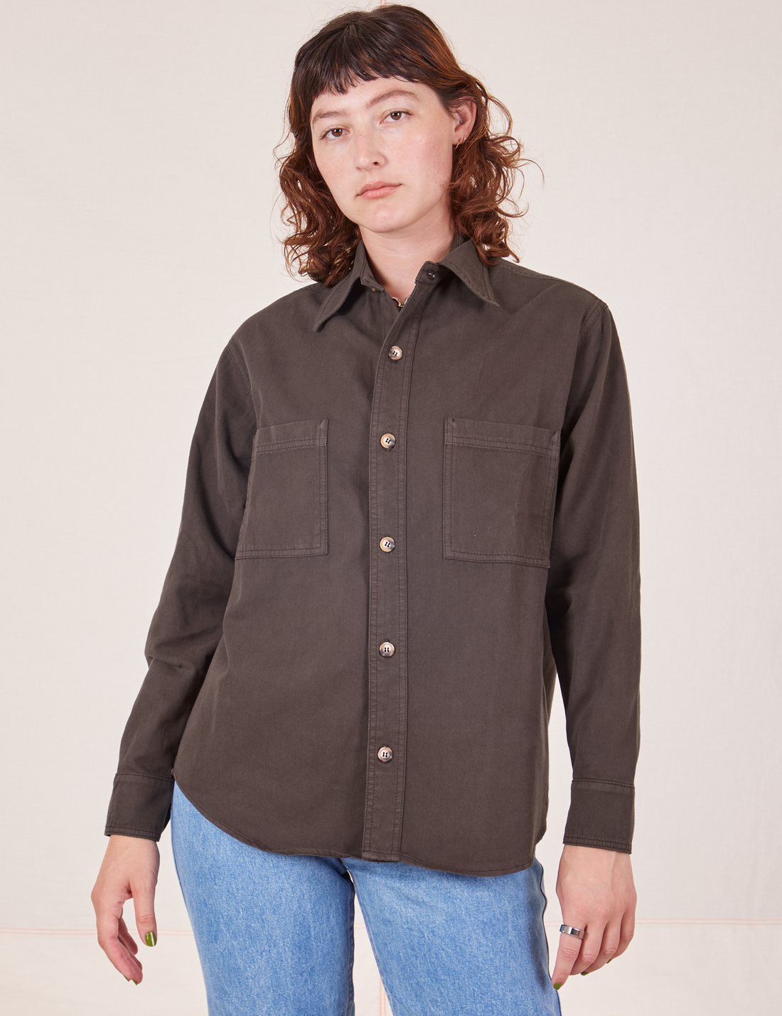 Alex is wearing a buttoned up Oversize Overshirt in Espresso Brown