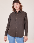 Alex is wearing a buttoned up Oversize Overshirt in Espresso Brown