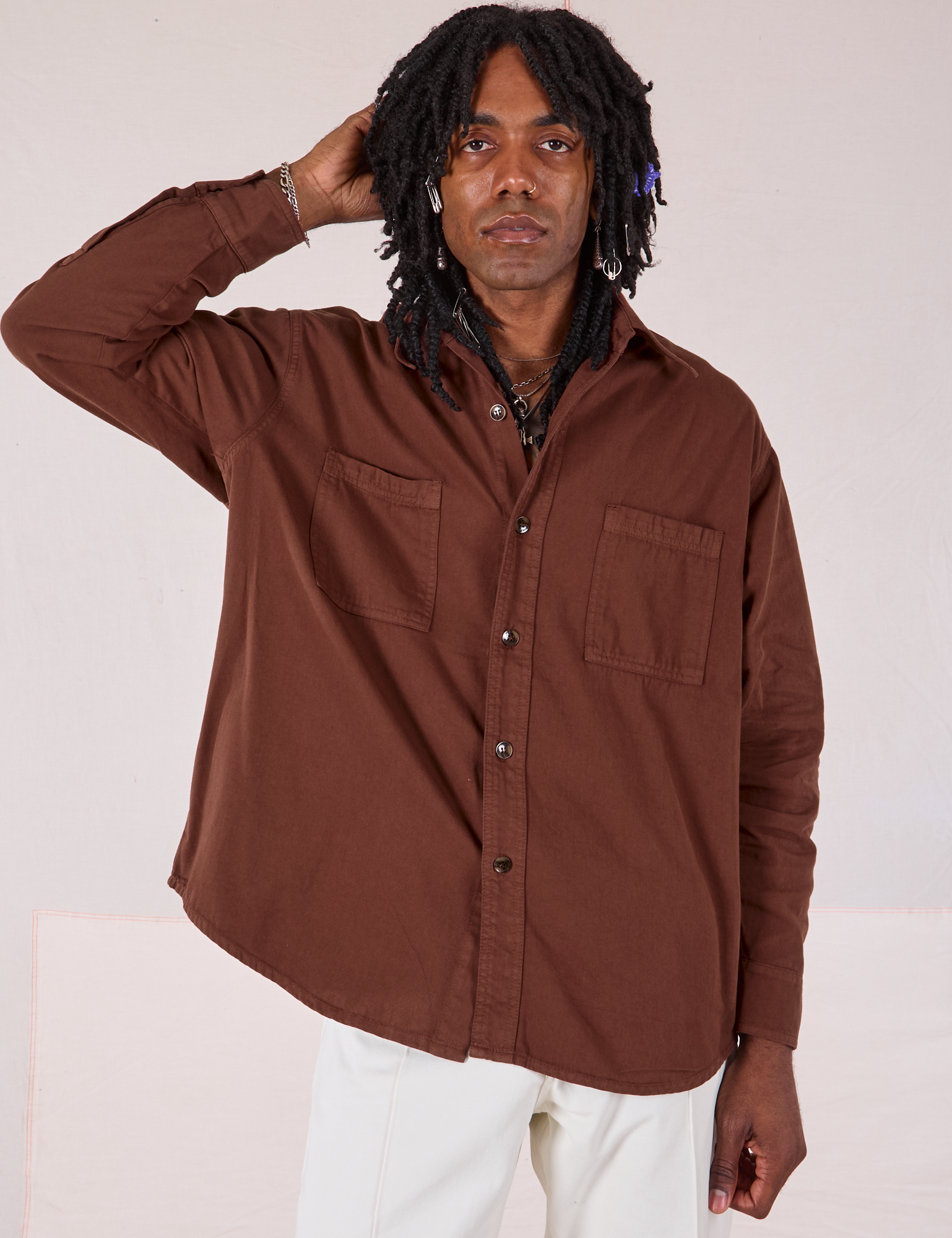 Jerrod is wearing a buttoned up Twill Overshirt in Fudgesicle Brown