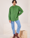 Jesse is wearing a buttoned up Oversize Overshirt in Lawn Green paired with light wash Frontier Jeans