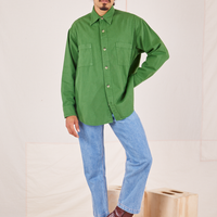 Jesse is wearing a buttoned up Oversize Overshirt in Lawn Green paired with light wash Frontier Jeans