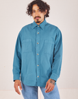 Jesse is wearing a buttoned up Oversize Overshirt in Marine Blue