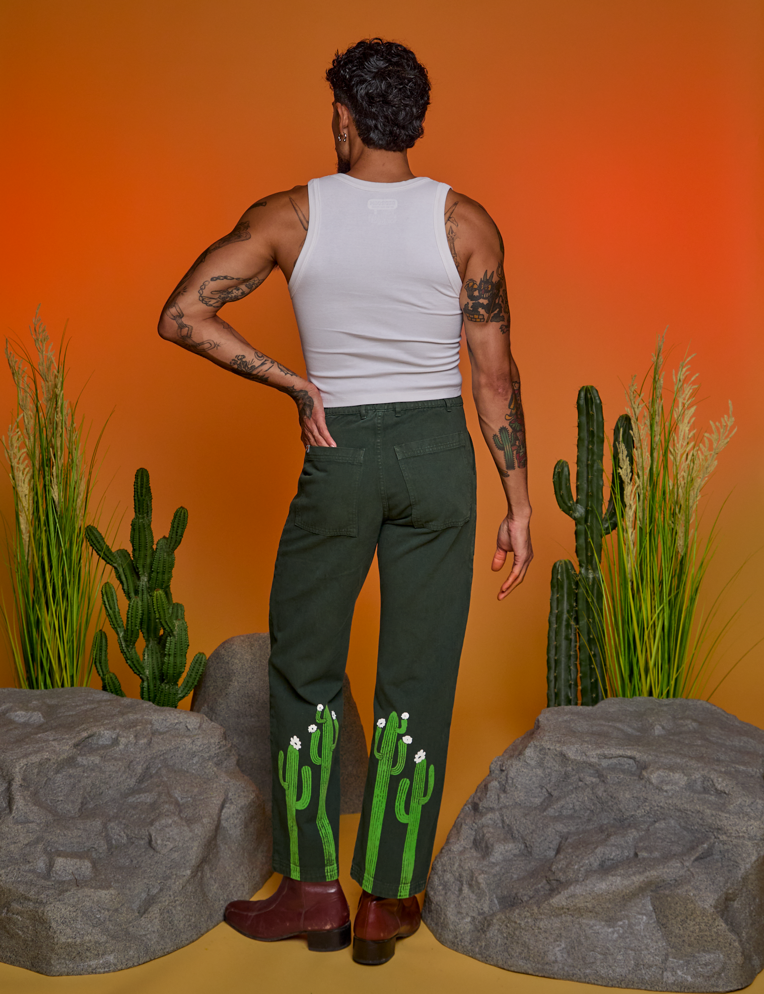 Back view of Paintstamped Work Pants in Cactus and Cropped Tank in Vintage Tee White on Jesse