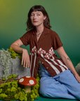 Alex is wearing Paintstamped Pantry Button-Up in Mushroom