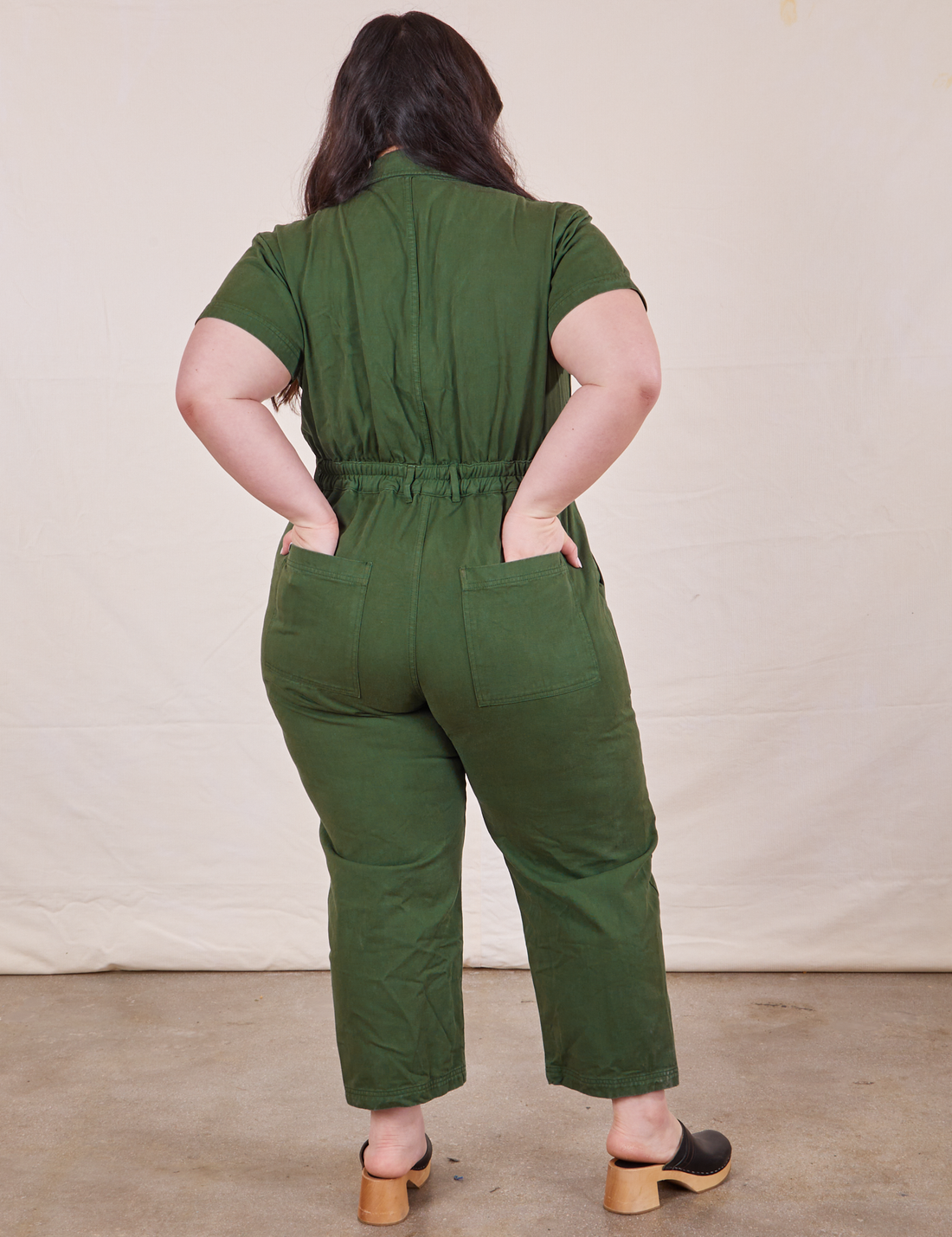 Petite Short Sleeve Jumpsuit in Dark Emerald Green back view on Ashley