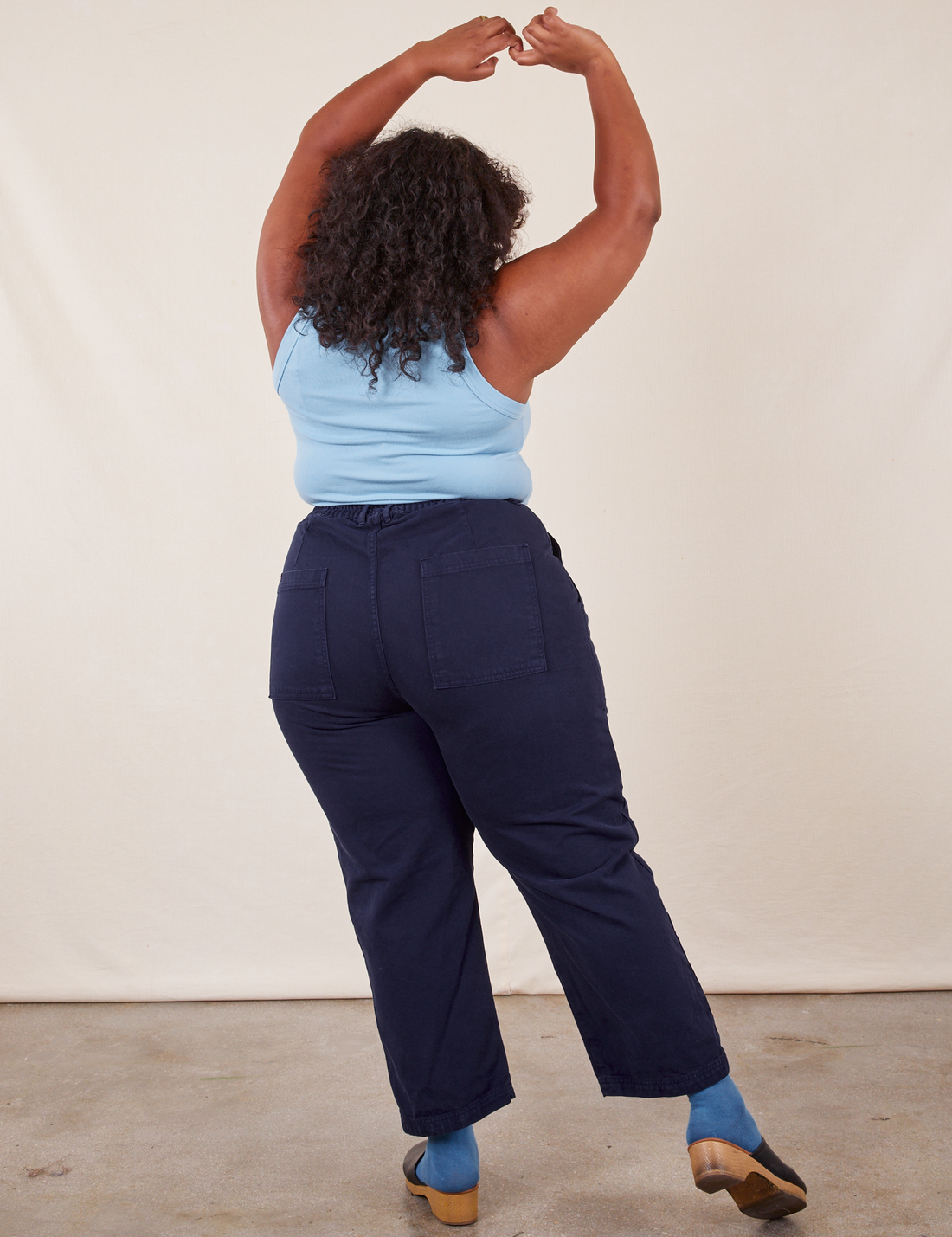Work Pants in Navy Blue back view on Morgan wearing baby blue Tank Top