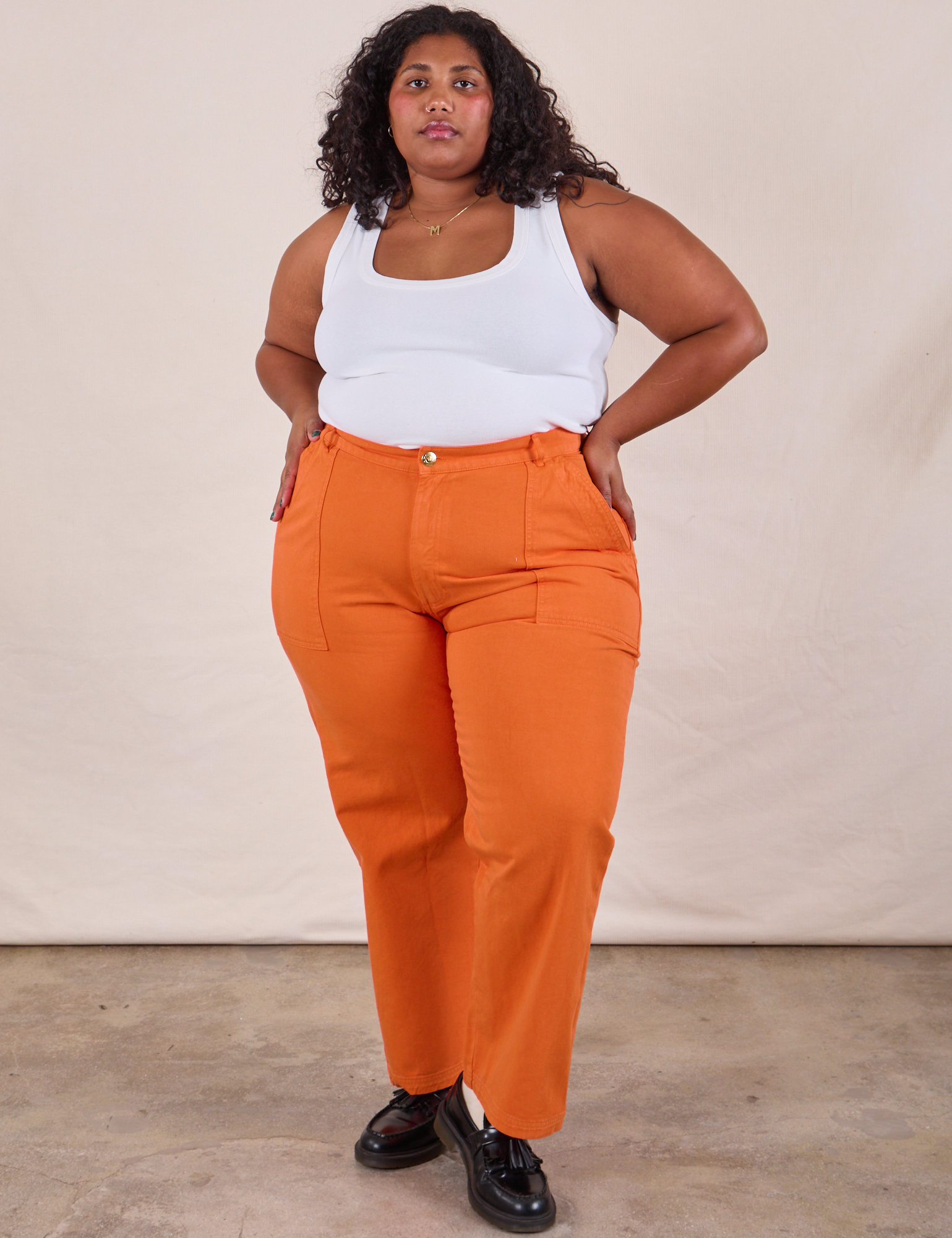 Morgan is 5&#39;5&quot; and wearing 2XL Work Pants in Construction Orange paired with Cropped Tank in Vintage Tee Off-White