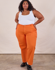 Morgan is 5'5" and wearing 2XL Work Pants in Construction Orange paired with Cropped Tank in Vintage Tee Off-White