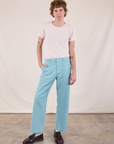 Quinn is 6’4” and wearing M Work Pants in Baby Blue paired with a Burly Tee in Vintage Tee Off-White