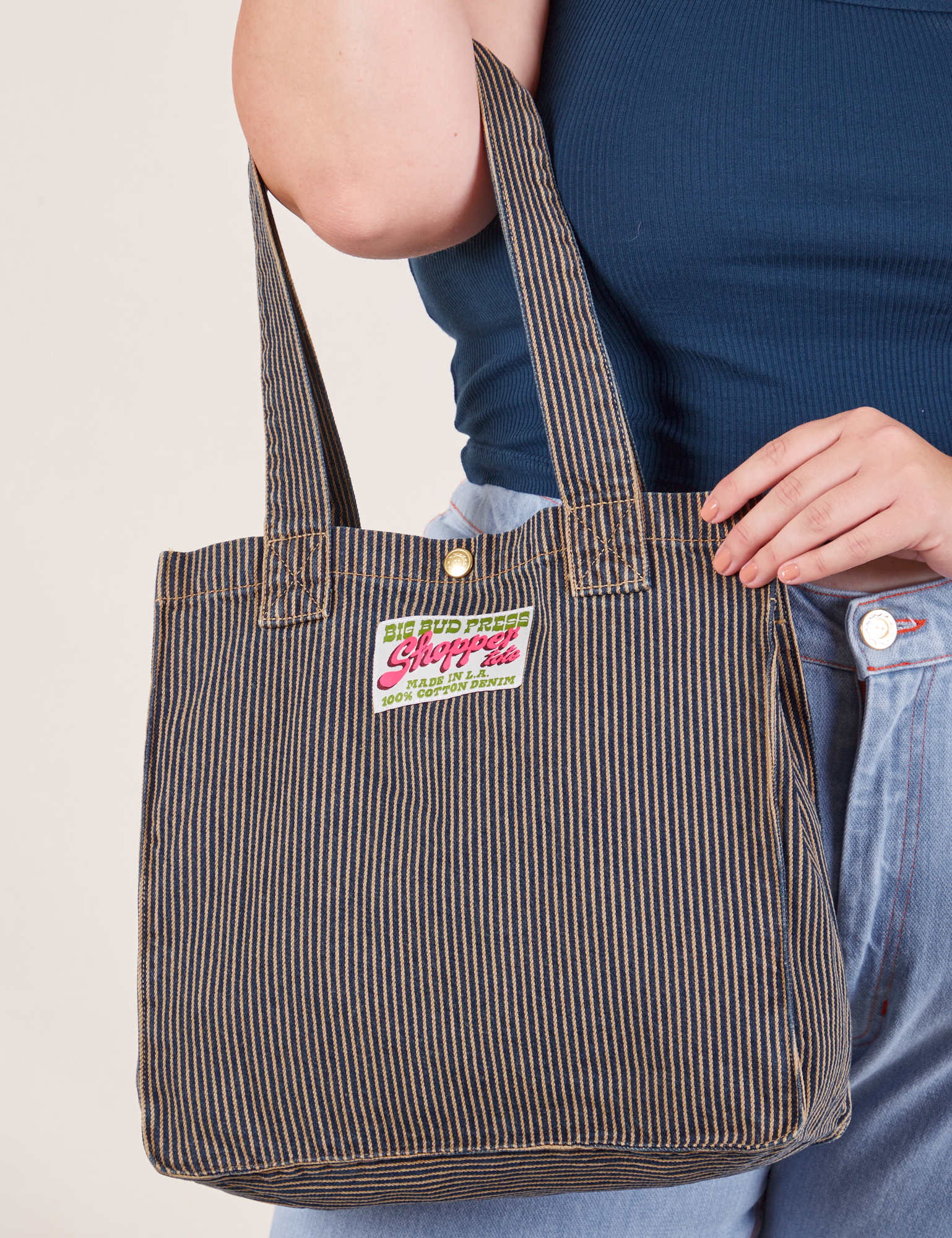 Railroad Shopper Tote in vintage tan worn on arm of model