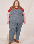 Catie is 5'11" and wearing 5XL Railroad Stripe Denim Original Overalls paired with paprika Baby Tee
