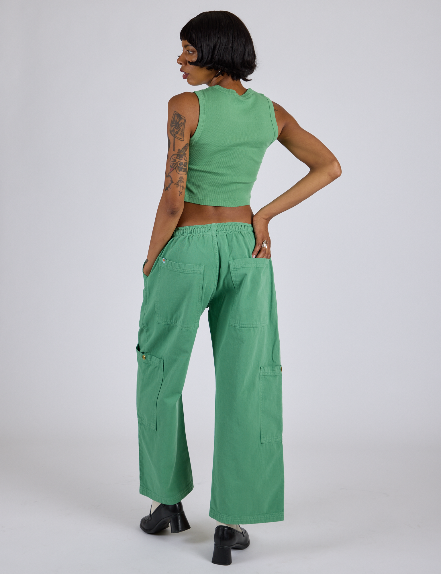 Back view of Drop Pocket Cargo Pants in Seafoam Green and matching Muscle Tee on Kira