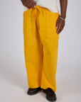Drop Pocket Cargo Pants in Sunshine Yellow close up on Isaac
