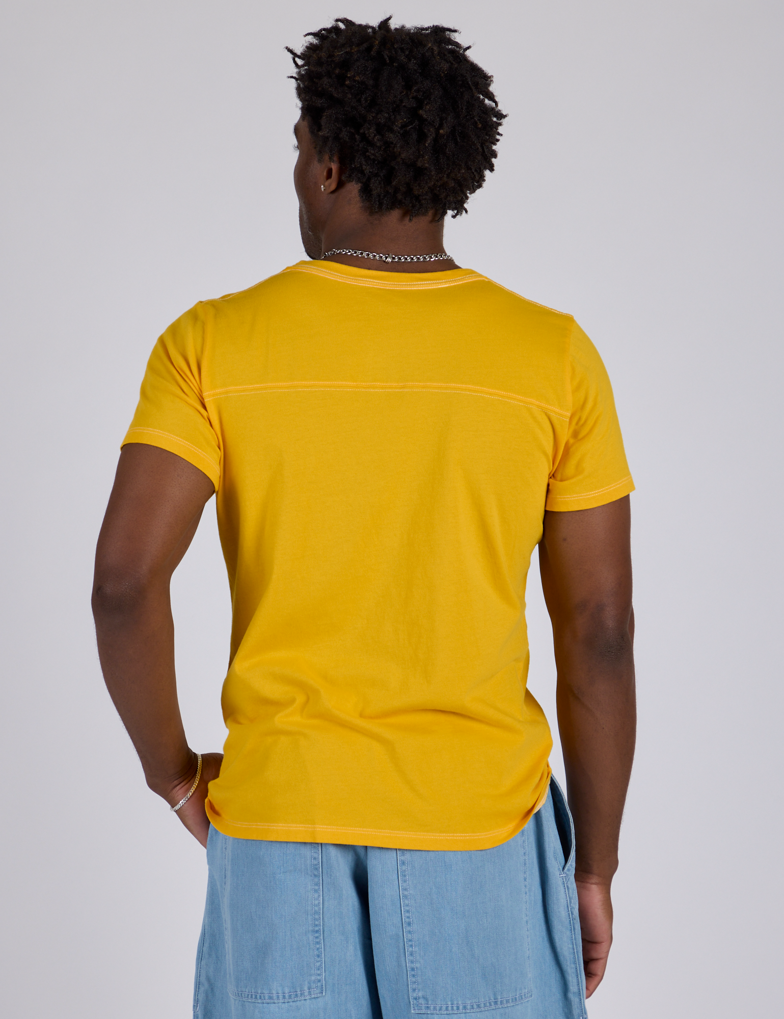 Jr. Varsity Tee in Sunshine Yellow back view on Isaac