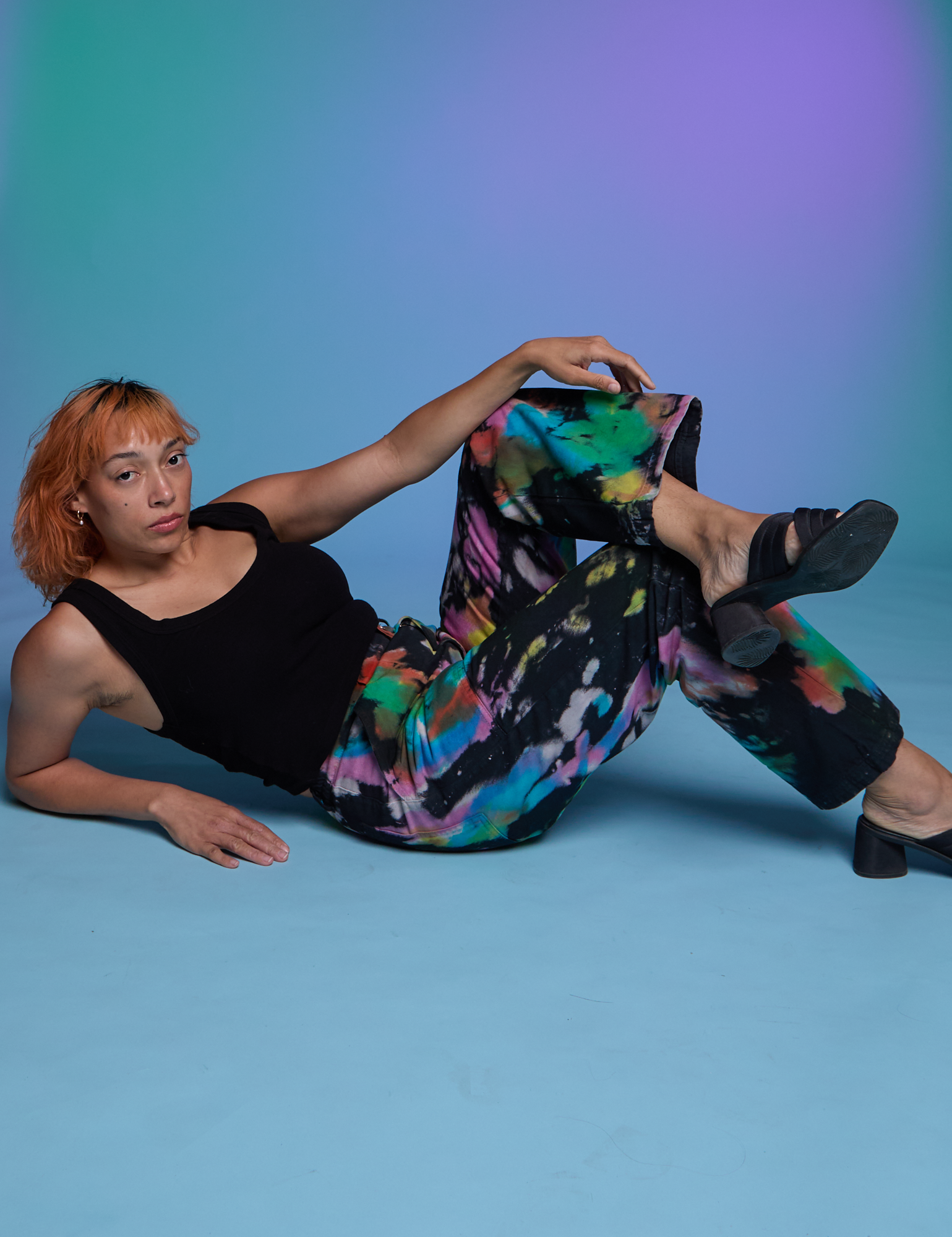 Tiara is wearing Work Pants in Rainbow Magic Waters and black Cropped Tank in Black