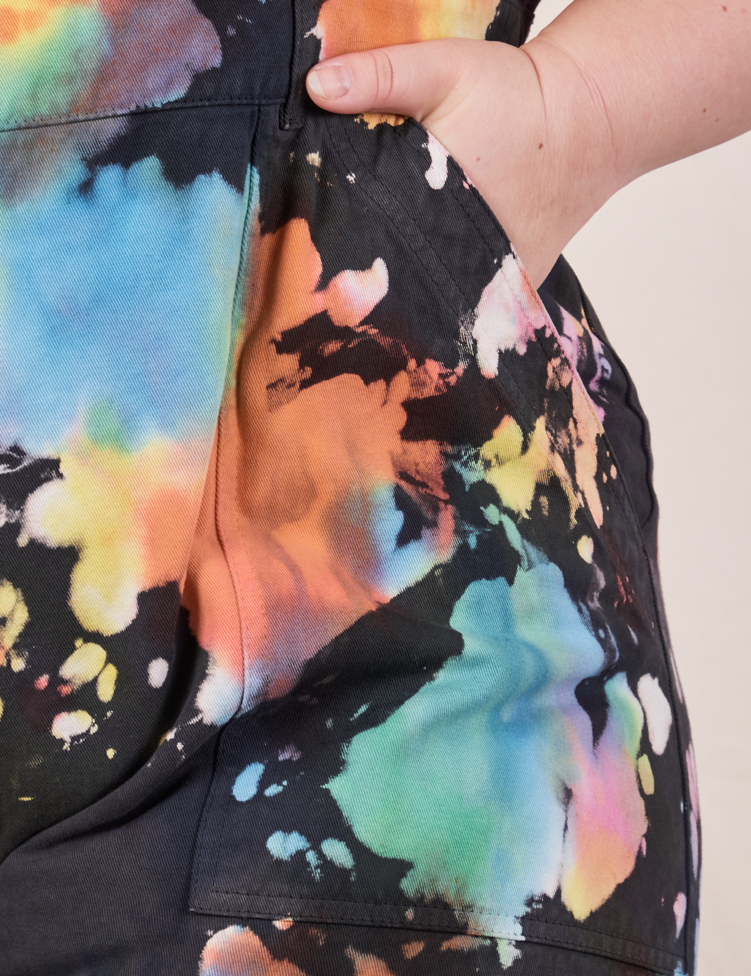 Front pocket close up of Petite Short Sleeve Jumpsuit in Rainbow Magic Waters worn by Ashley