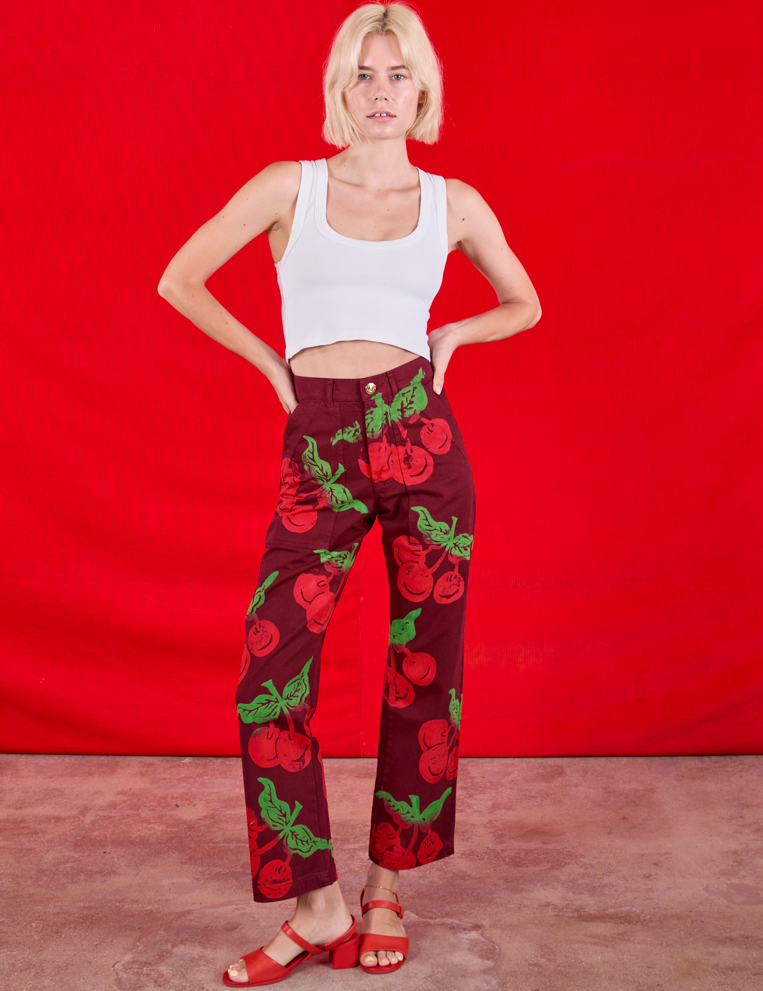 Madeline is 5&#39;9&quot; and wearing XXS Paintstamped Work Pants in Cherry paired with a Cropped Tank in Vintage Tee Off-White