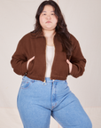 Ashley is 5'7" and wearing L Ricky Jacket in Fudgesicle Brown paired with a vintage off-white Tank Top and Big Bud Press denim pants