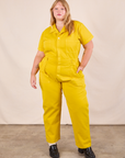 Juliet is 5'7" and wearing 1XL Short Sleeve Jumpsuit in Golden Yellow