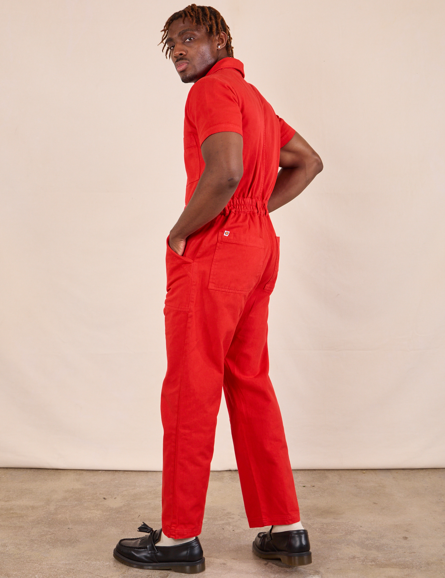 Short Sleeve Jumpsuit in Mustang Red back view on Issac