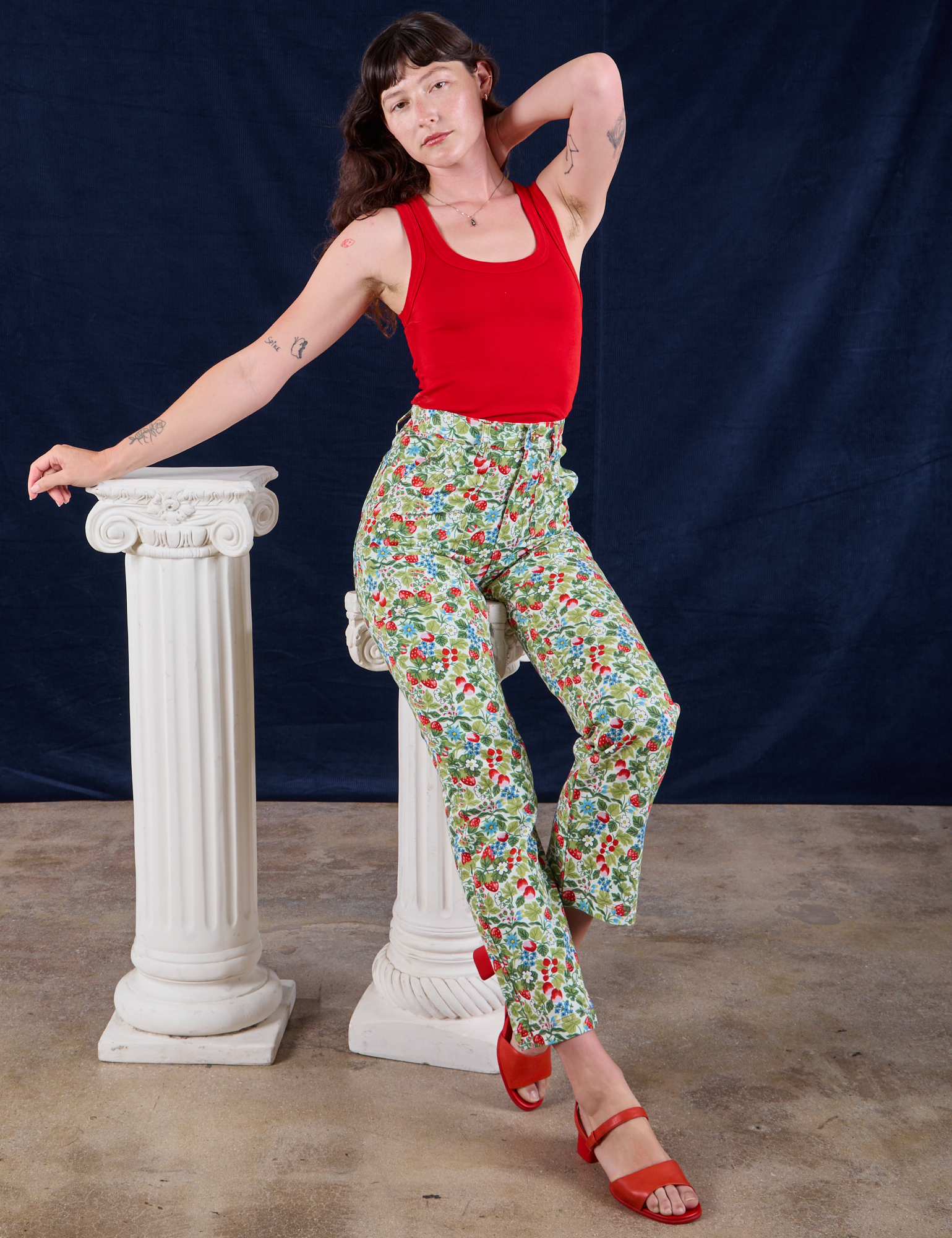 Alex is wearing Work Pants in Strawberry Blossom and mustang red Tank Top