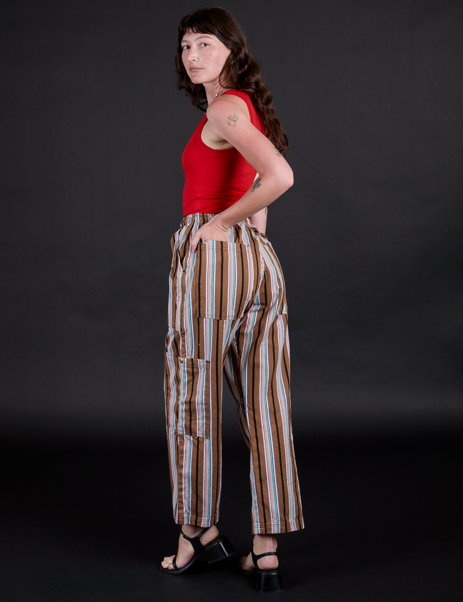 Striped Drop Pocket Pants in Retro Rainbow angled back view on Alex
