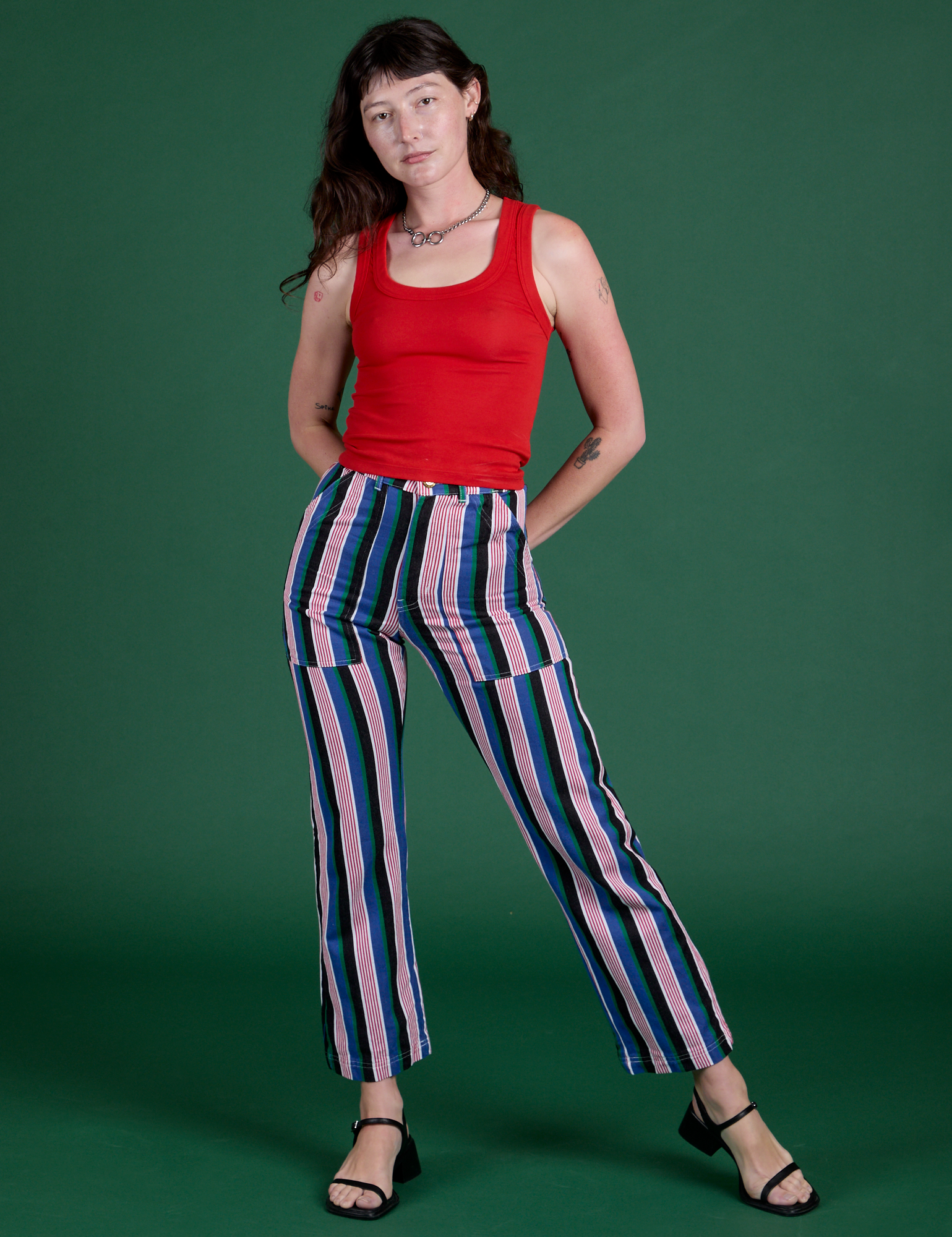Alex is 5’8” and wearing XXS Work Pants in Pacific Stripe paired with mustang red Cropped Tank