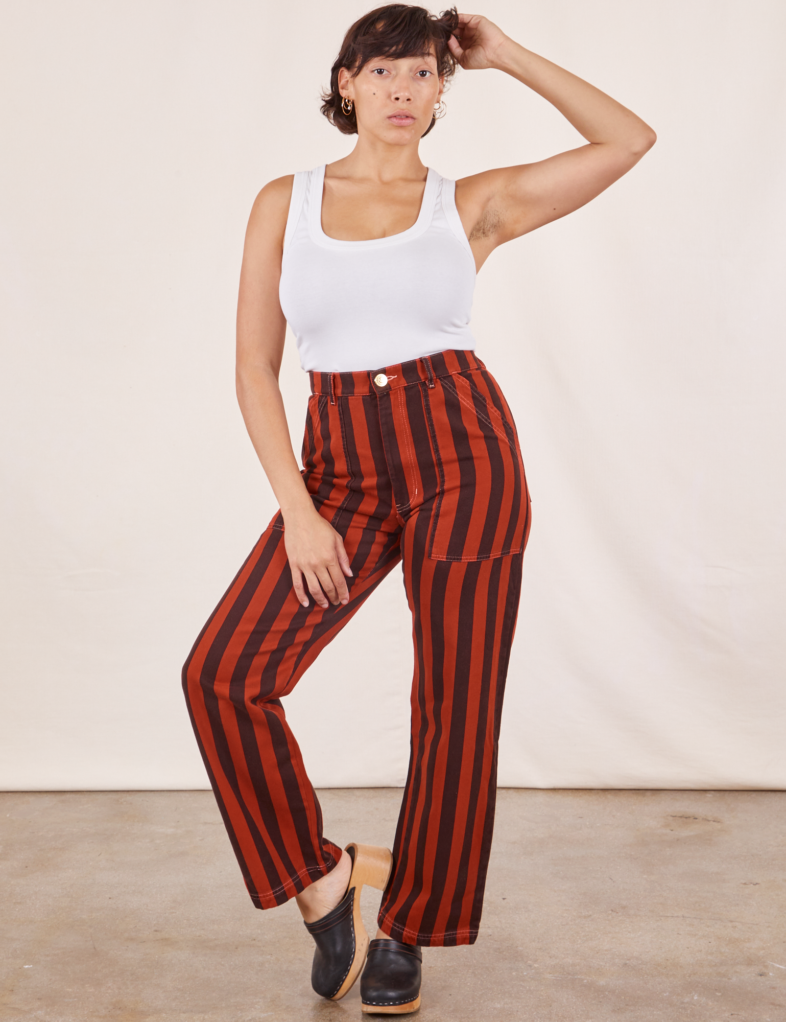 Tiara is 5&#39;4&quot; and wearing S Black Striped Work Pants in Paprika paired with vintage off-white Cropped Tank Top