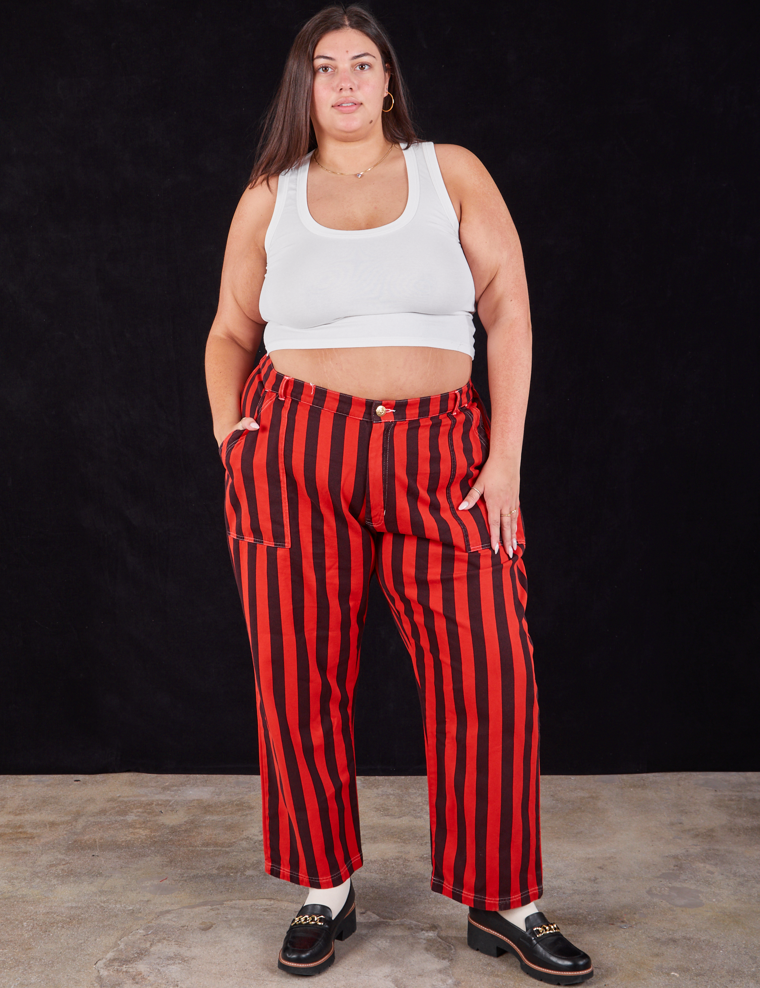 Katie is 6&#39;2&quot; and wearing 2XL Black Stripe Work Pants in Mustang Red paired with a Cropped Tank in vintage tee off-white