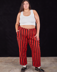 Katie is 6'2" and wearing 2XL Black Stripe Work Pants in Mustang Red paired with a Cropped Tank in vintage tee off-white