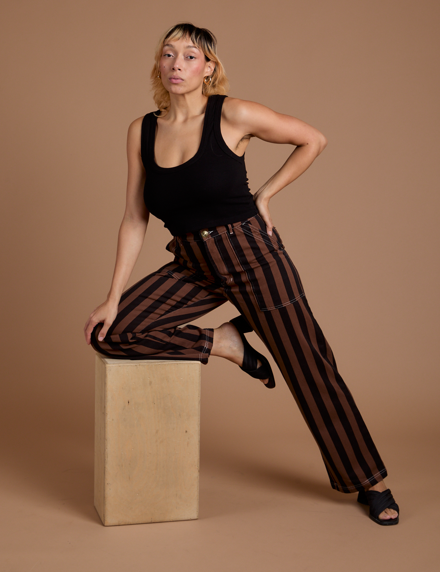 Tiara is wearing Black Stripe Work Pants in Fudgesicle Brown and black Cropped Tank