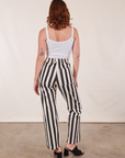 Back view of Black Striped Work Pants in White and vintage off-white Cropped Cami on Alex