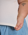 Close up of Juliet holding The Tank Top in Vintage Tee Off-White bottom hem