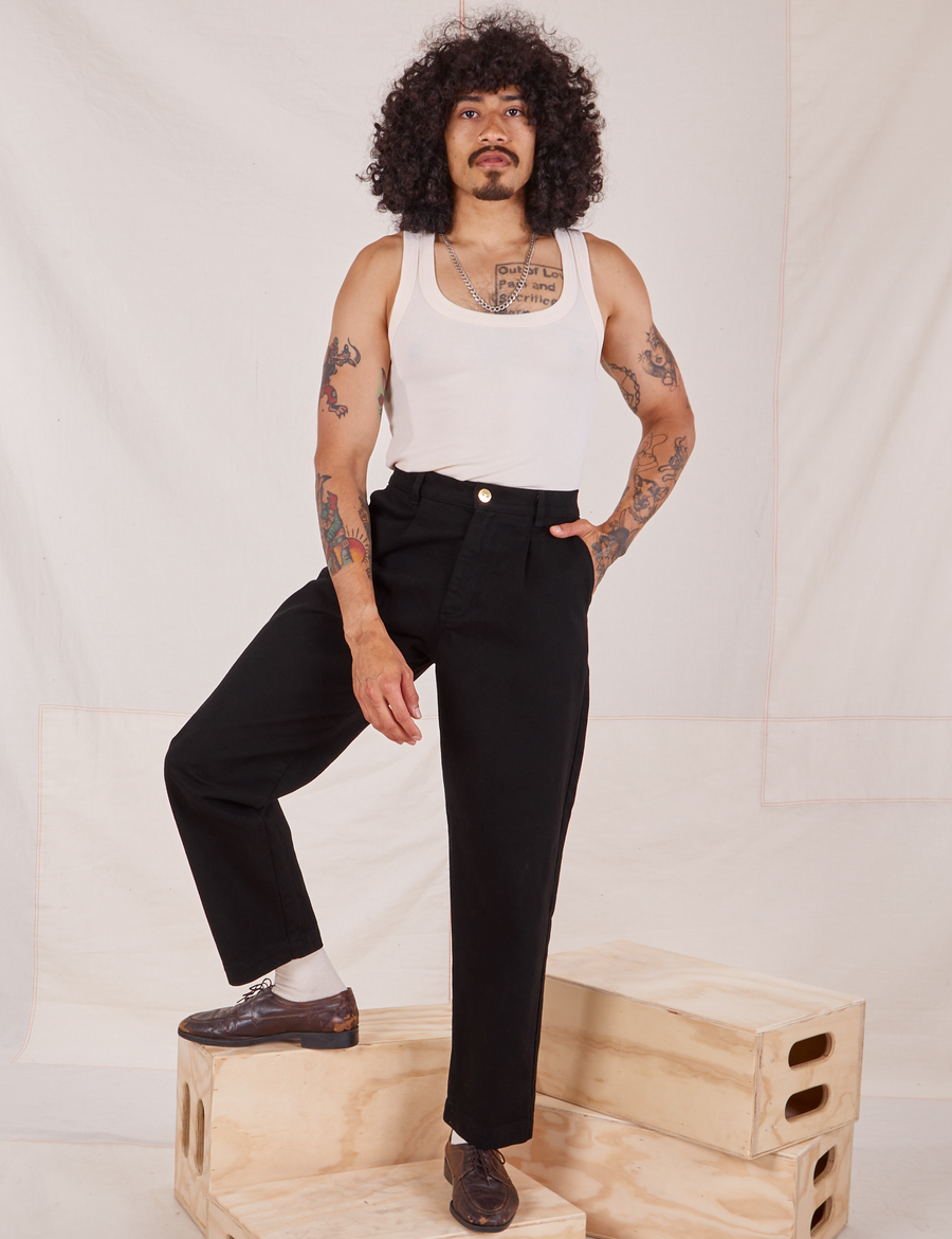 Jesse is wearing Denim Trouser Jeans in Black and vintage off-white Tank Top