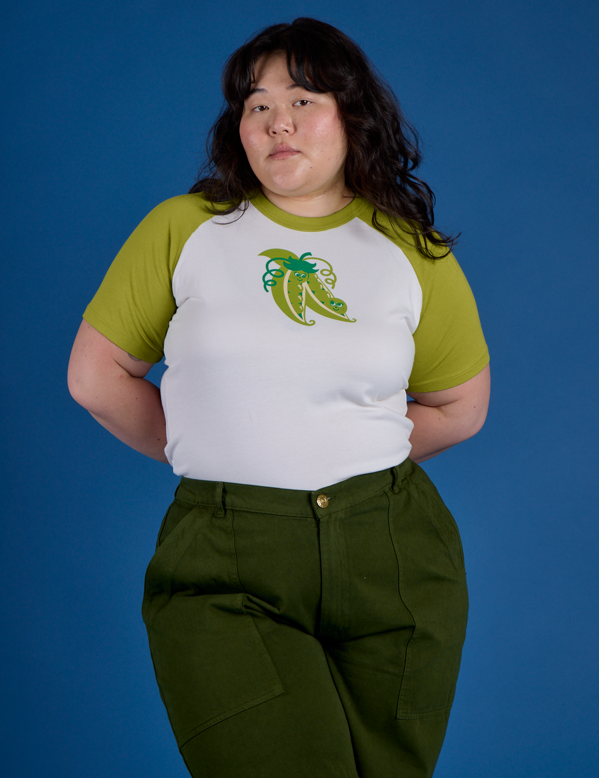 Ashley is 5’7” and wearing XL Produce Raglan Tee in Snap Peas