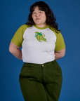 Ashley is 5’7” and wearing XL Produce Raglan Tee in Snap Peas