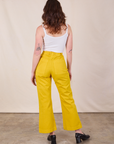 Back view of Western Pants in Golden Yellow and Cropped Cami in Vintage Tee Off-White on Alex