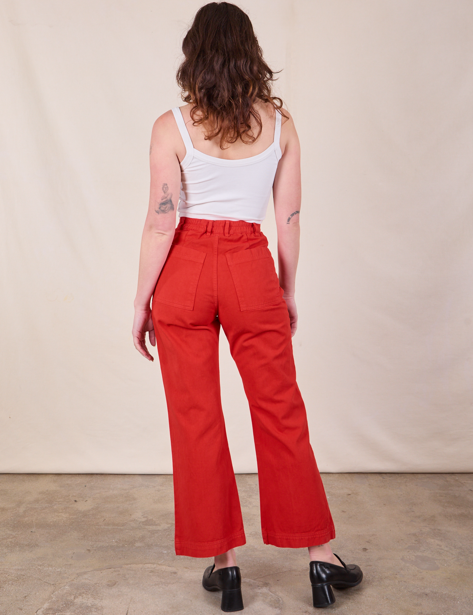 Back view of Western Pants in Mustang Red and Cropped Cami in Vintage Tee Off-White on Alex