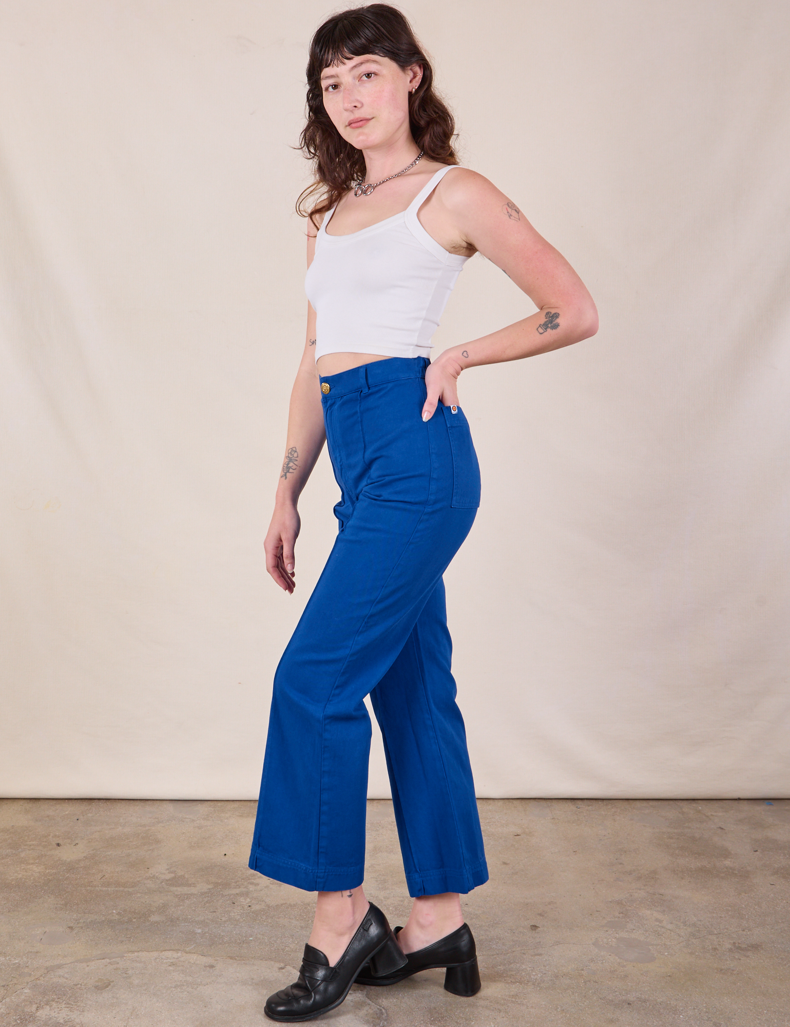 Side view of Western Pants in Royal Blue and Cropped Cami in Vintage Tee Off-White