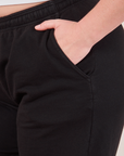 Wide Leg Sweat Pants in Basic Black side pocket close up with Lish's hand in it.