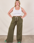 Lish is 5'8" and wearing M Wide Leg Sweat Pants in Surplus Green paired with Cropped Tank in vintage tee off-white