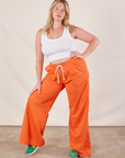 Lish is 5'8" and wearing M Wide Leg Sweat Pants in Sunset Orange