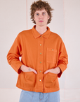 Quinn is wearing a buttoned up Denim Work Jacket in Construction Orange