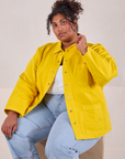 Morgan is wearing Denim Work Jacket in Golden Yellow and light wash Carpenter jeans