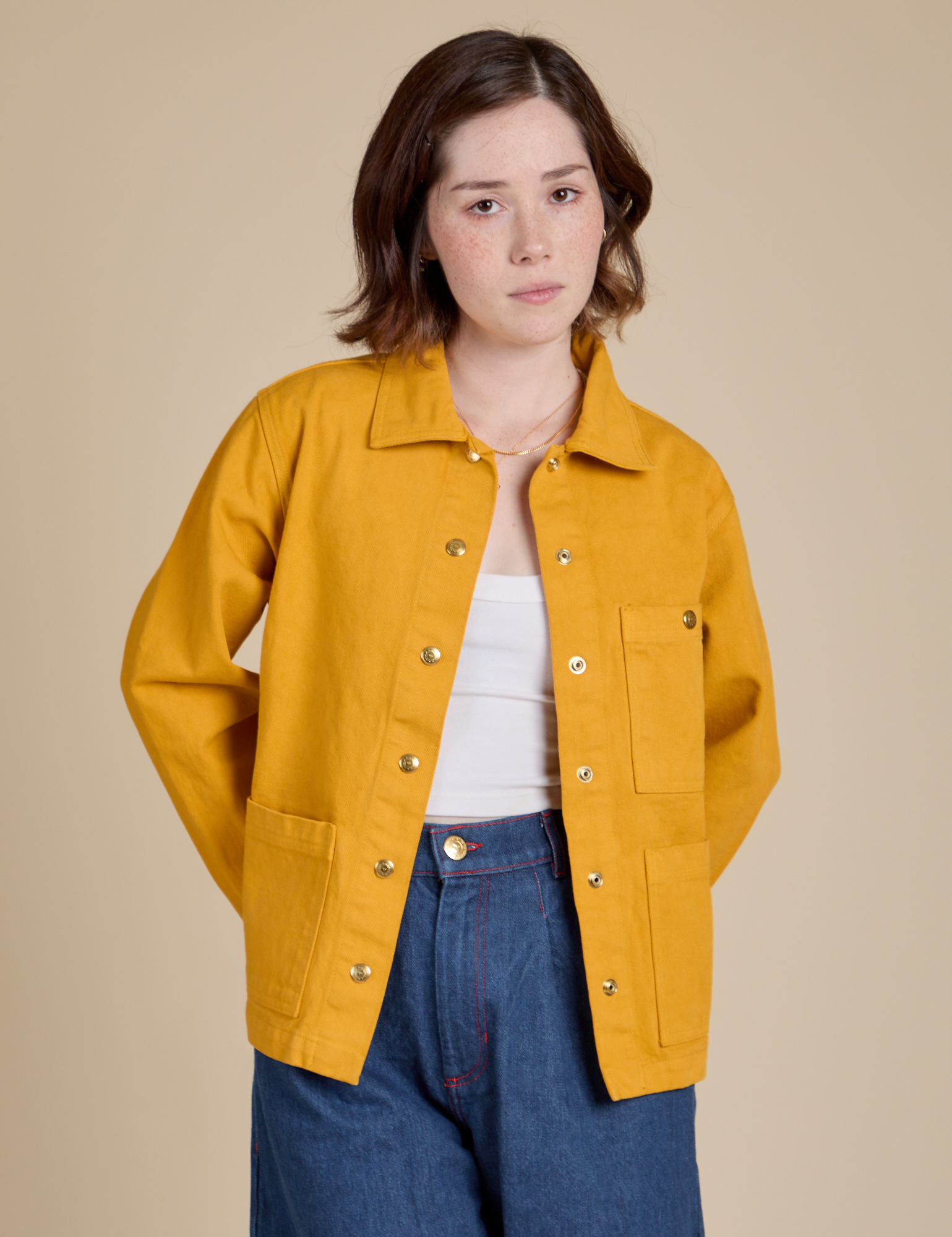 Hana is 5&#39;3&quot; and wearing P Denim Work Jacket in Mustard Yellow